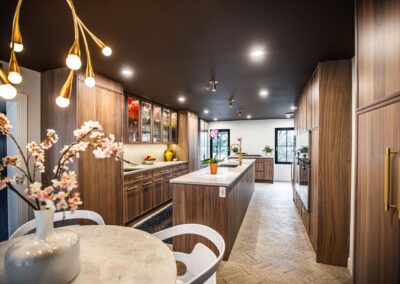 A spacious kitchen featuring a large island going down the center and elegant wooden cabinets