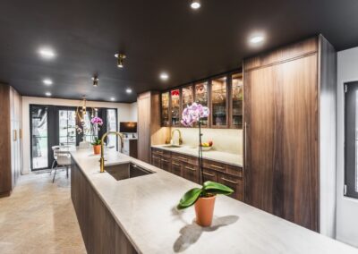 A spacious kitchen featuring a large island going down the center and elegant wooden cabinets